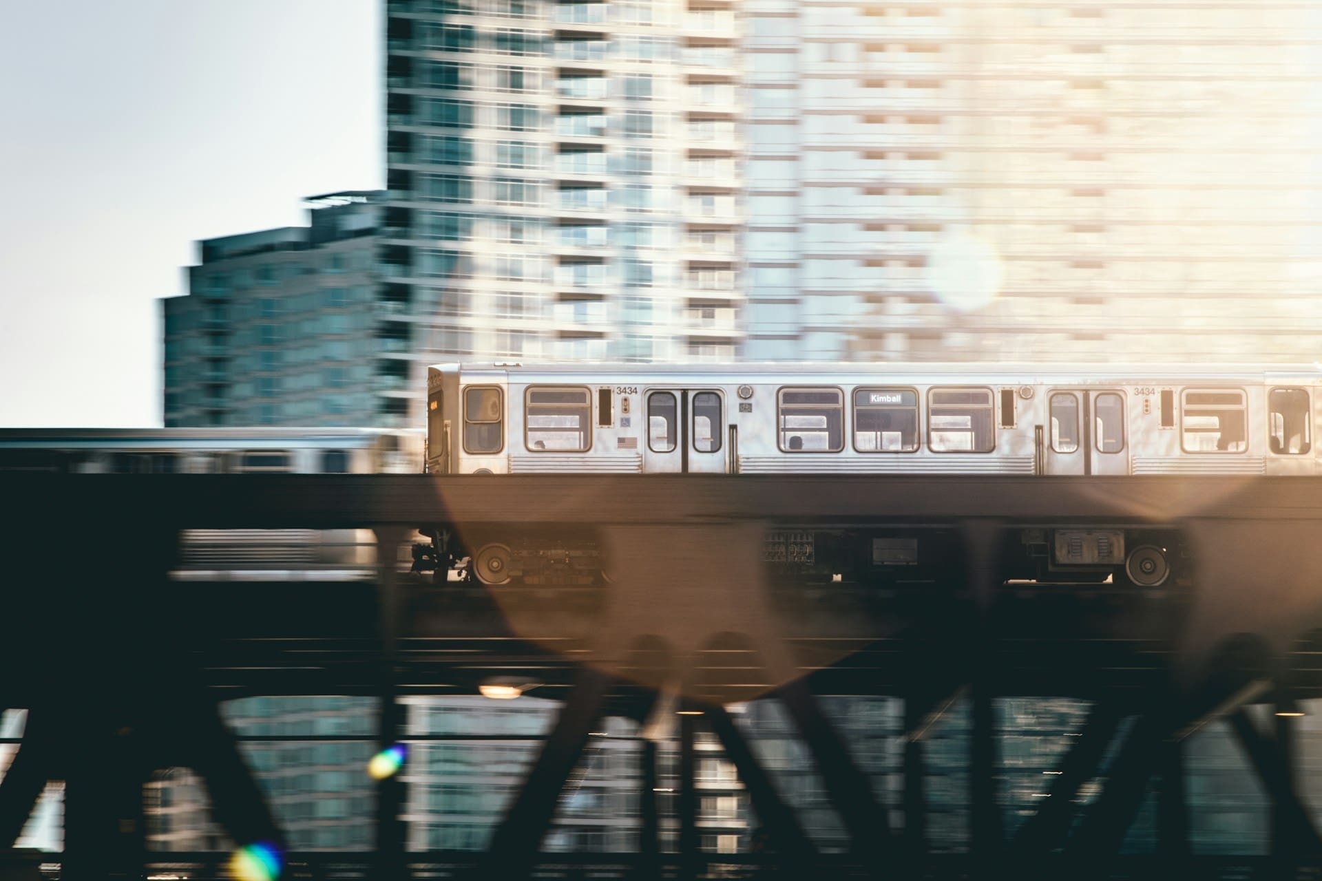 A train in Chicago moving past a building.
