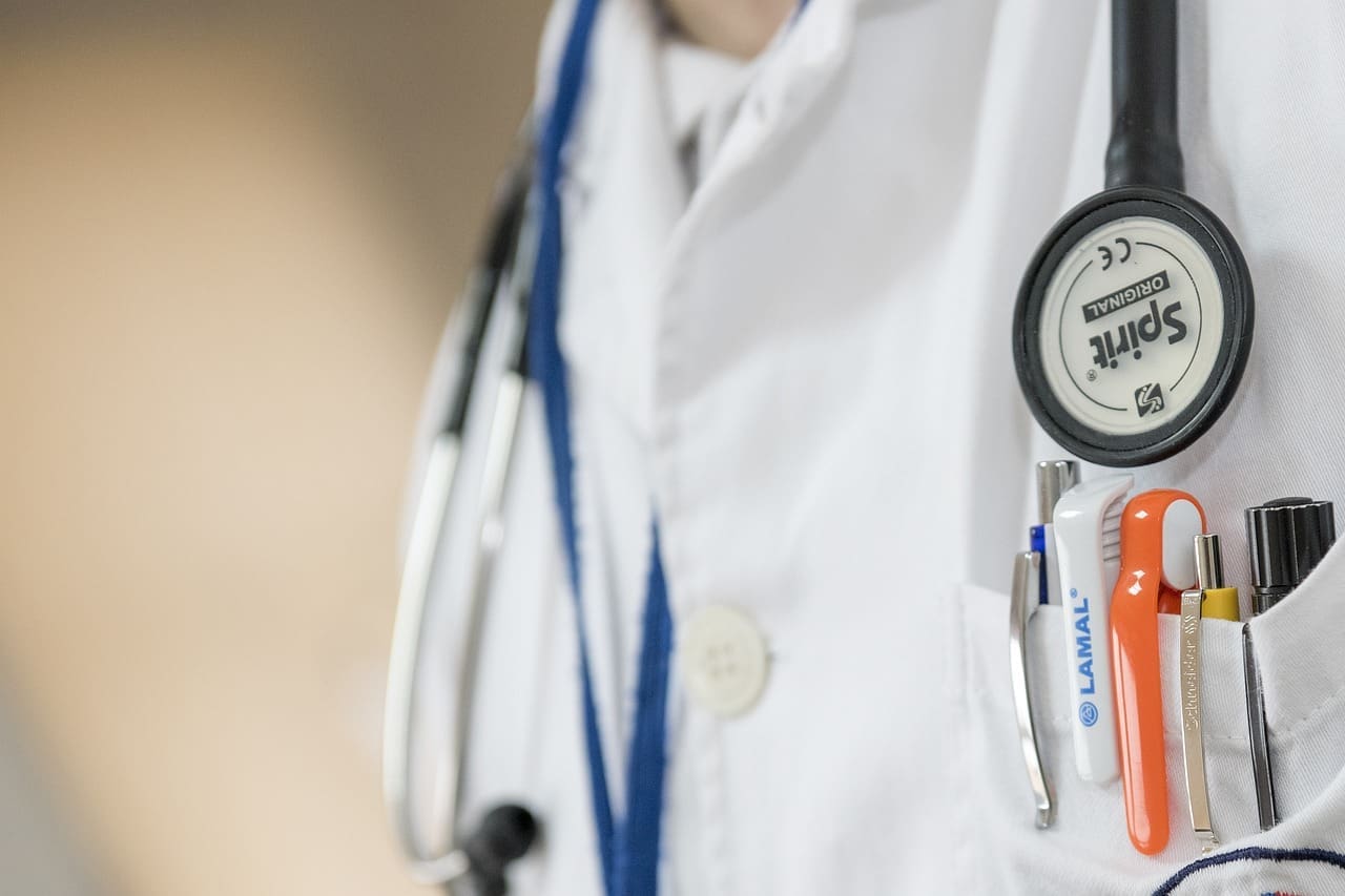 A close up photo of a doctor wearing their badge.