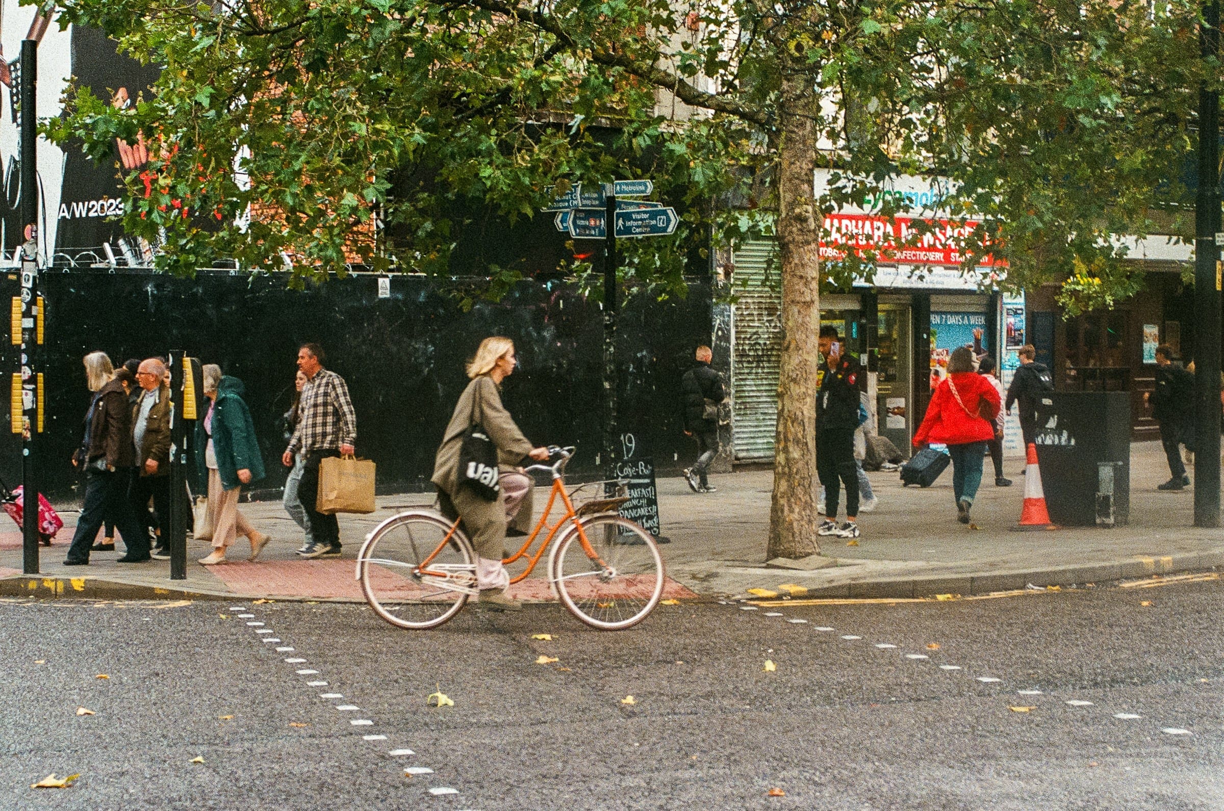 A photo of pedestrians and bicyclists on a pedestrian friendly street.