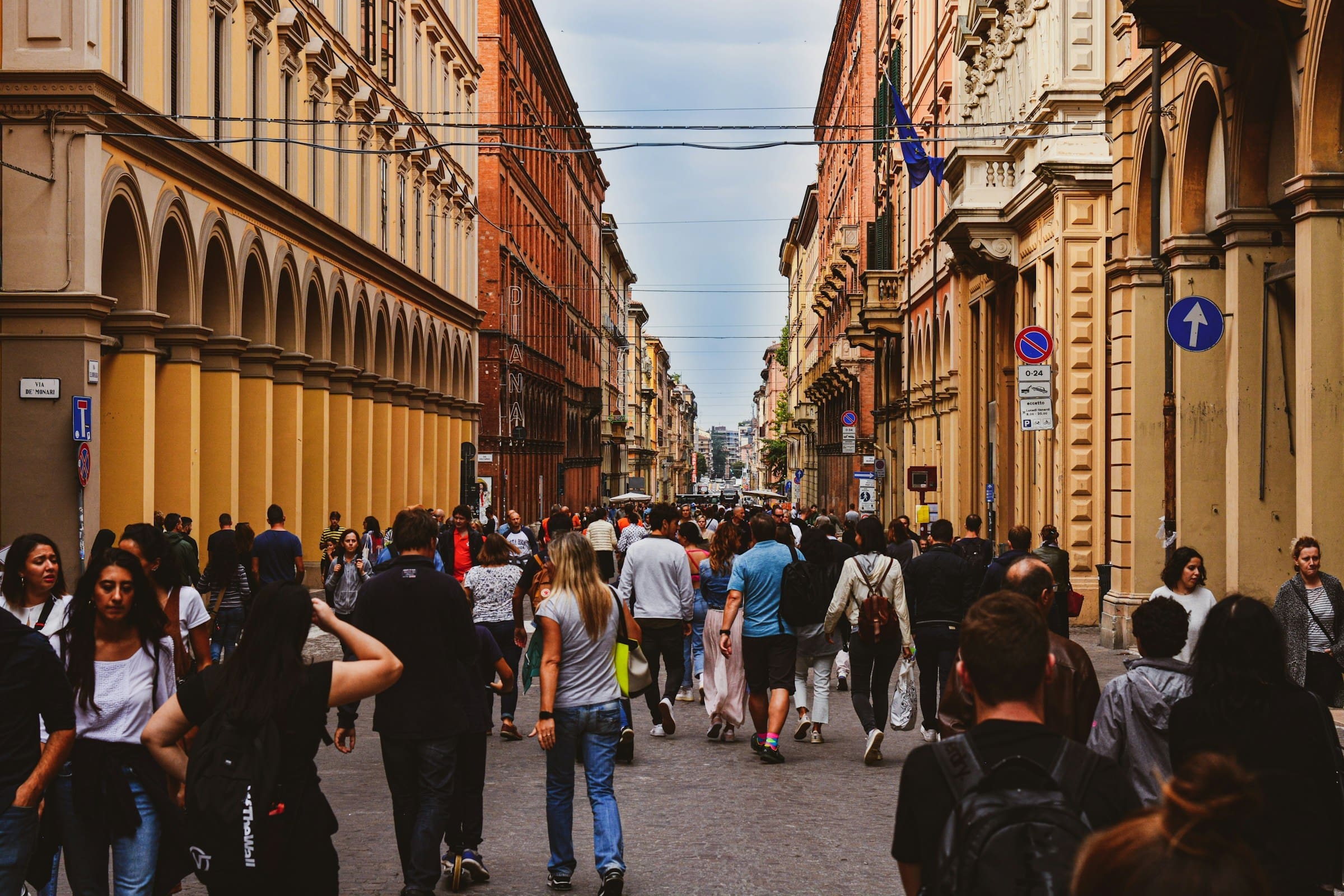 A crowd of tourists walking down a city street.